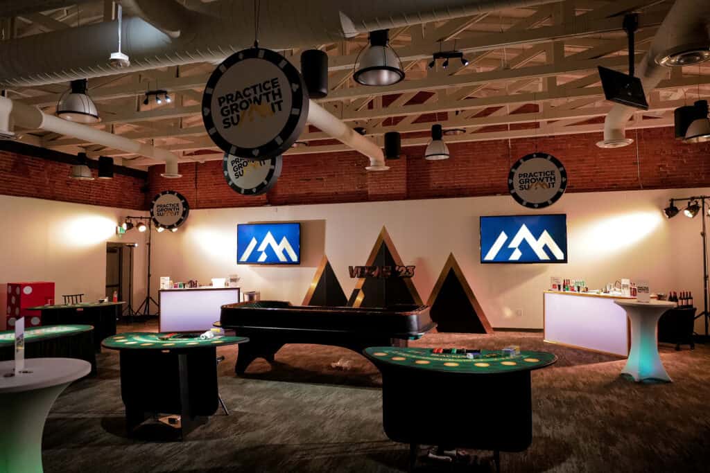 Indoor gaming area with poker tables, screens, and modern decor at On Jackson.